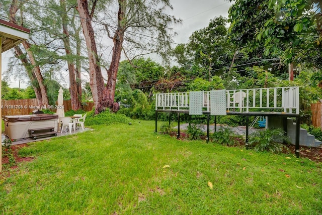 view of yard featuring a hot tub and a wooden deck