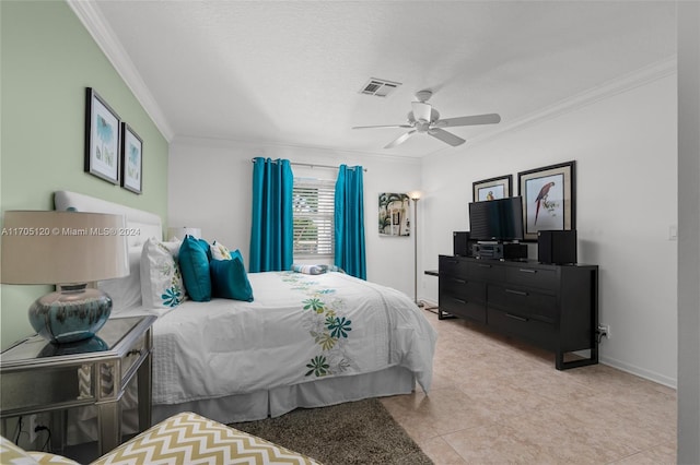 tiled bedroom with a textured ceiling, ceiling fan, and ornamental molding