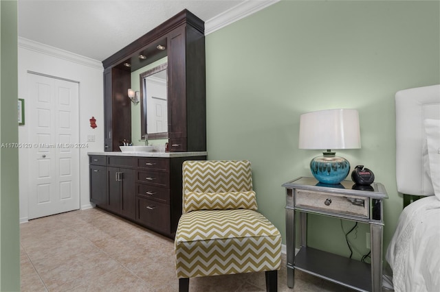 bathroom with crown molding, tile patterned flooring, and vanity