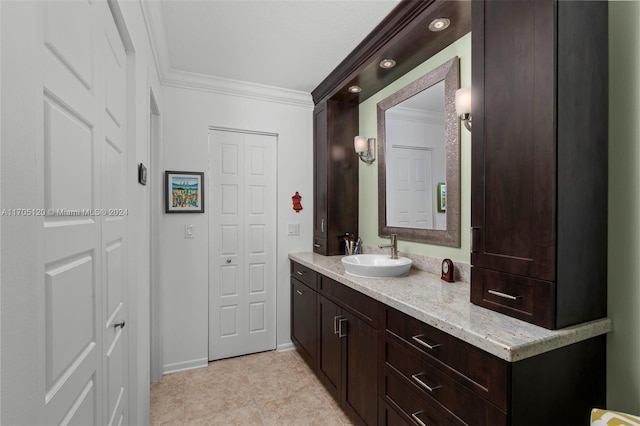 bathroom featuring vanity, tile patterned floors, and crown molding