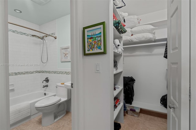 bathroom featuring tile patterned floors, toilet, and tiled shower / bath