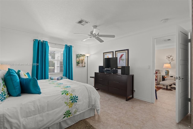 bedroom featuring ceiling fan, ornamental molding, and a textured ceiling