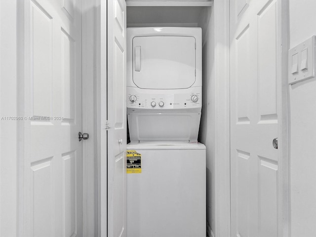 laundry area featuring stacked washer and clothes dryer