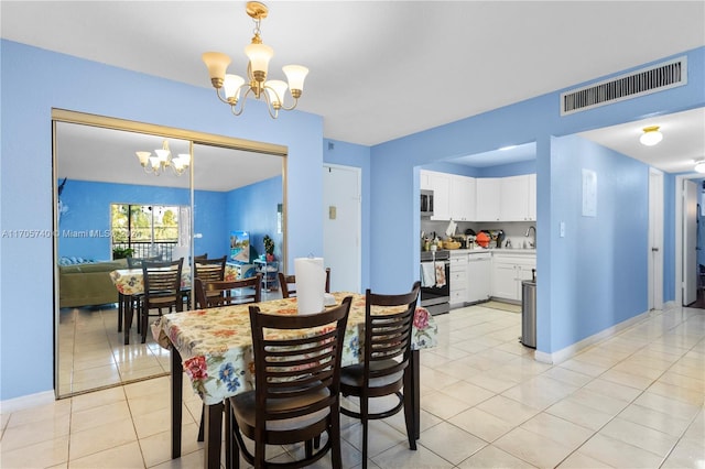 dining room featuring a chandelier and light tile patterned flooring