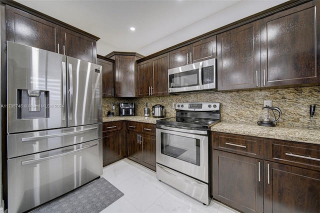 kitchen featuring dark brown cabinets, light stone countertops, backsplash, and appliances with stainless steel finishes