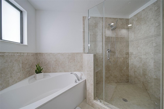 bathroom with shower with separate bathtub