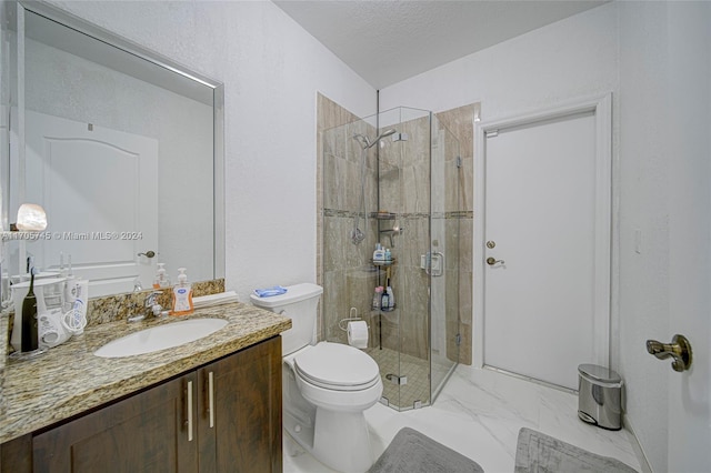 bathroom with a textured ceiling, vanity, toilet, and walk in shower