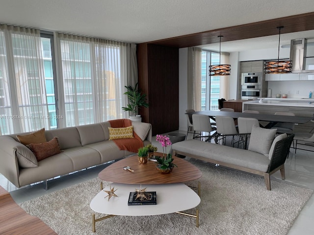 living room with a textured ceiling, hardwood / wood-style flooring, and an inviting chandelier