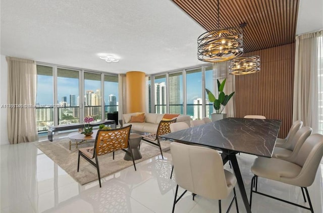 330 Sunny Isles Blvd Unit 5-2407, Sunny Isles Beach, FL 33160 - dining room with a chandelier, a wall of windows, a view of skyline, and tile patterned floors