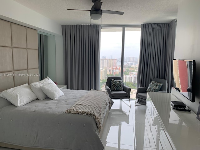 330 Sunny Isles Blvd Unit 5-2407, Sunny Isles Beach, FL 33160 - bedroom featuring expansive windows, a textured ceiling, tile patterned flooring, and a ceiling fan