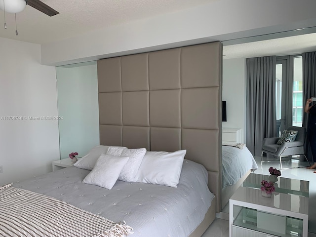 bedroom featuring a textured ceiling and ceiling fan