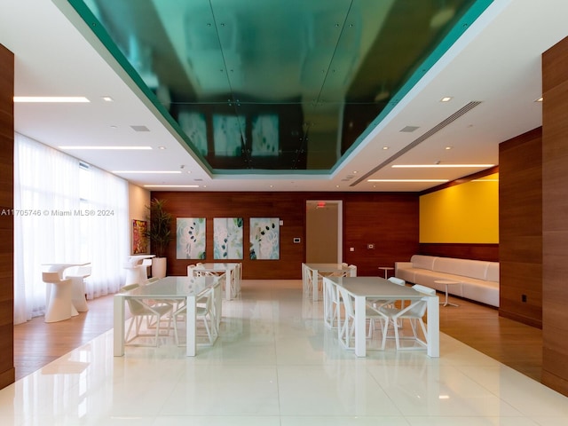 330 Sunny Isles Blvd Unit 5-2407, Sunny Isles Beach, FL 33160 - dining space featuring wooden walls, tile patterned floors, and a tray ceiling