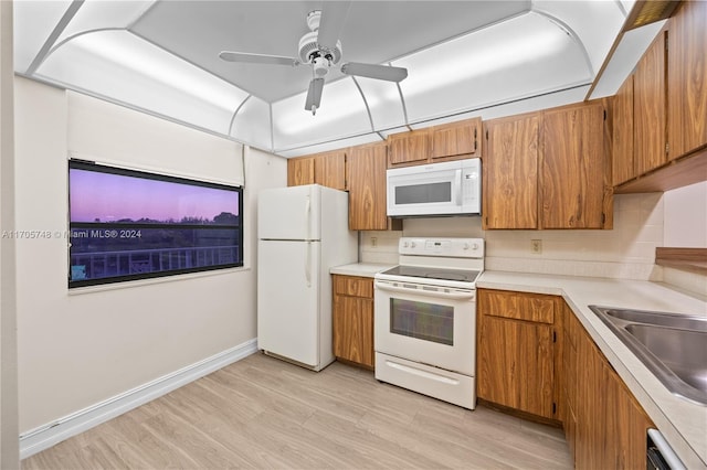 kitchen featuring decorative backsplash, light wood-type flooring, white appliances, ceiling fan, and sink