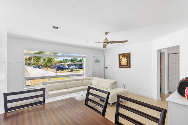 tiled living room with ceiling fan