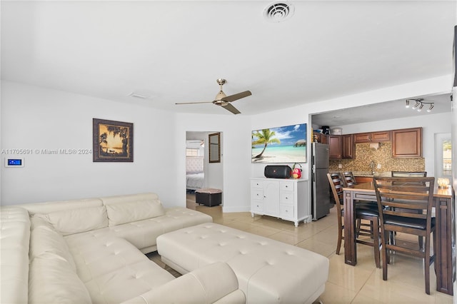 living room featuring ceiling fan and light tile patterned floors