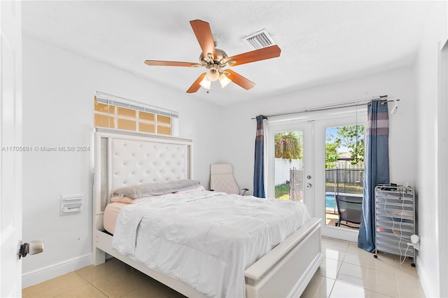 tiled bedroom featuring ceiling fan, access to exterior, a textured ceiling, and french doors