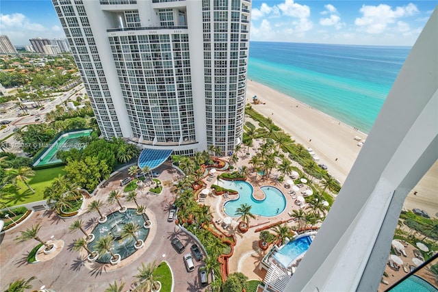 aerial view with a water view and a beach view