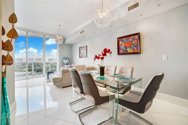 dining space featuring light tile patterned floors, a chandelier, and a wall of windows