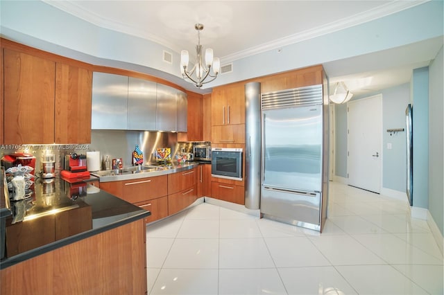 kitchen with backsplash, hanging light fixtures, built in appliances, ornamental molding, and light tile patterned flooring