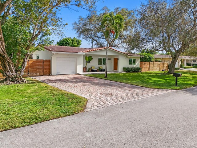 view of front facade with a garage and a front lawn