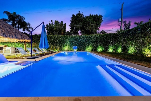 view of pool at dusk