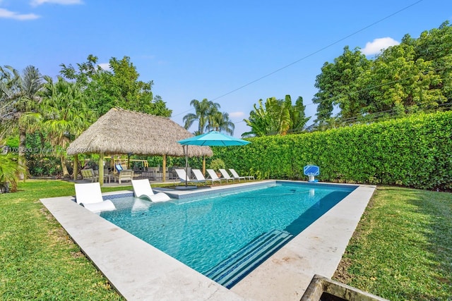 view of swimming pool featuring a gazebo and a lawn