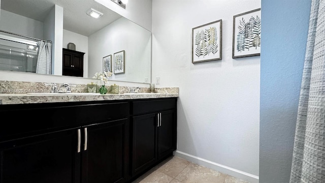 bathroom with tile patterned flooring, a shower with curtain, and vanity