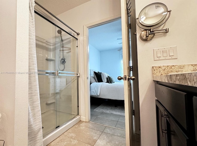 bathroom with tile patterned flooring and walk in shower