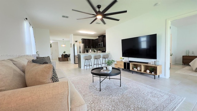 tiled living room featuring ceiling fan