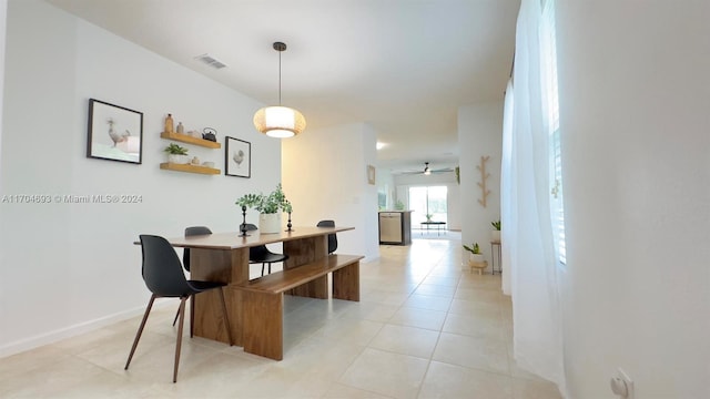 tiled dining room featuring ceiling fan