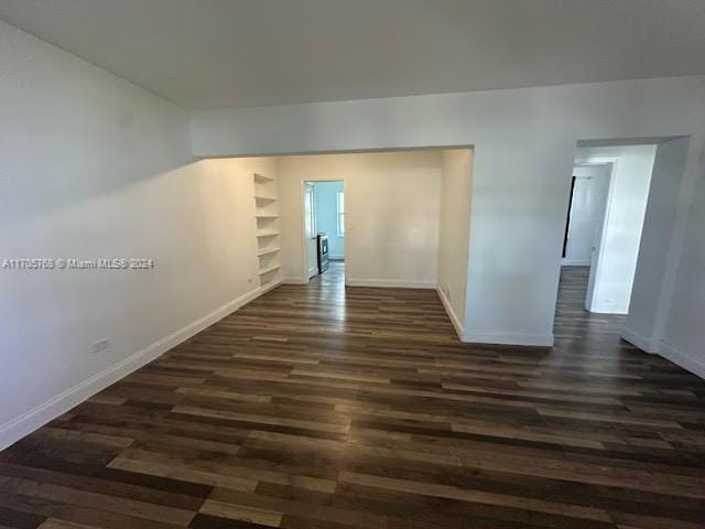 interior space featuring built in features and dark hardwood / wood-style floors