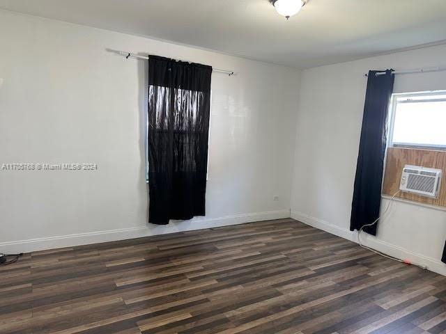 empty room featuring dark hardwood / wood-style floors and cooling unit