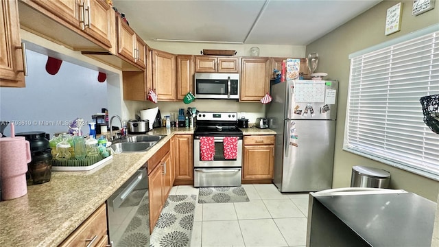 kitchen featuring sink, light tile patterned floors, and appliances with stainless steel finishes