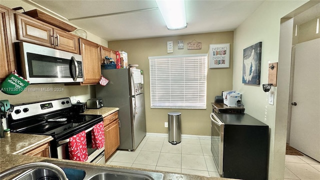 kitchen featuring light tile patterned flooring and appliances with stainless steel finishes