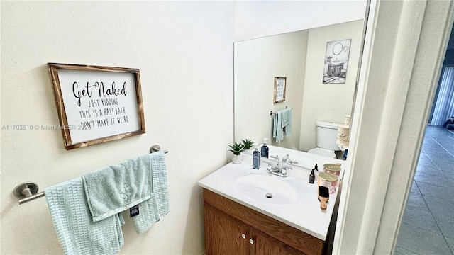 bathroom with tile patterned floors, vanity, and toilet