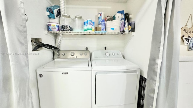 washroom with washing machine and clothes dryer