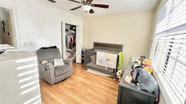 sitting room featuring hardwood / wood-style floors, a textured ceiling, and ceiling fan