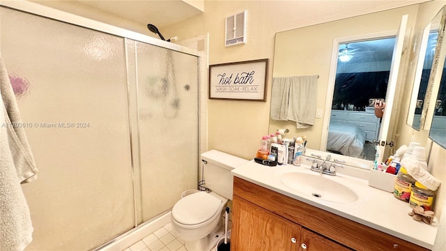 bathroom featuring tile patterned floors, vanity, toilet, and walk in shower