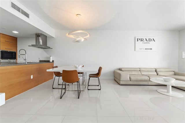 dining space featuring light tile patterned floors and sink