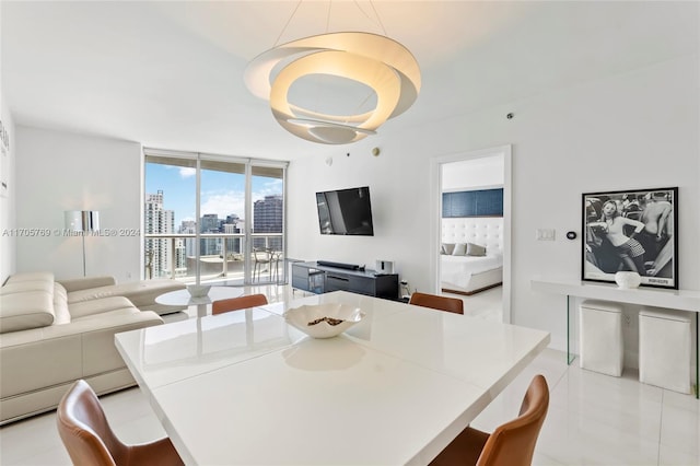 dining area featuring light tile patterned floors and floor to ceiling windows