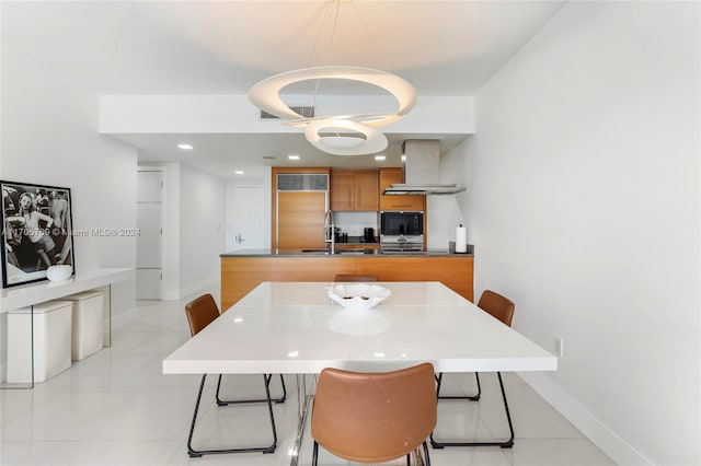 tiled dining room featuring sink