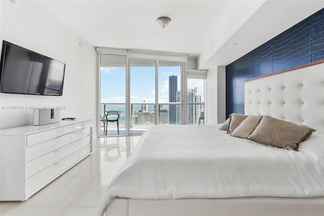 bedroom featuring floor to ceiling windows, light tile patterned floors, and access to outside