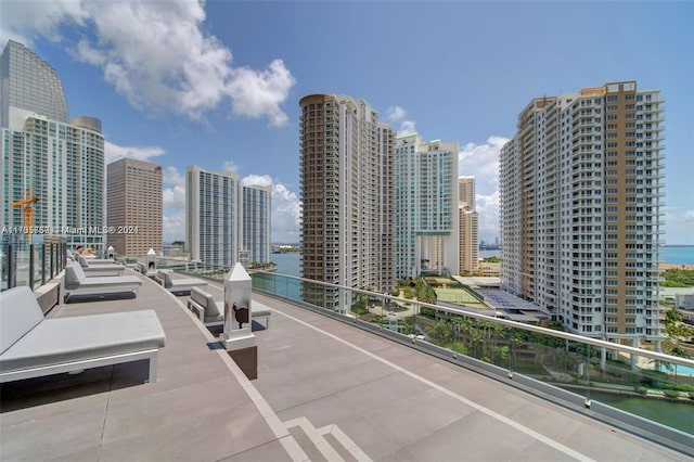 view of patio / terrace featuring a water view and a balcony