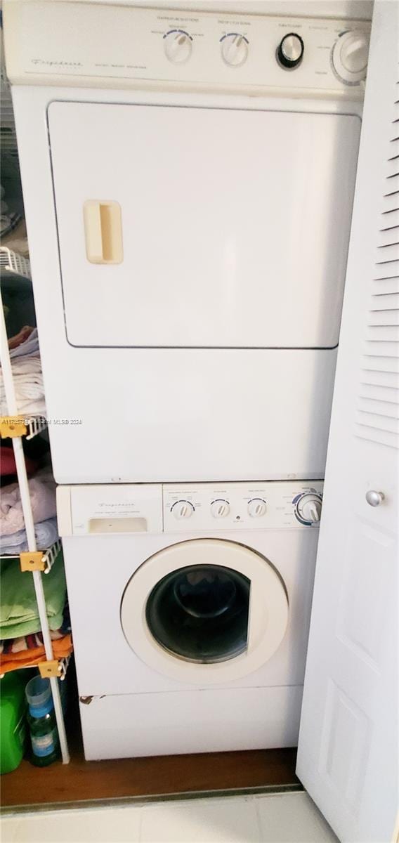 laundry area with stacked washer / dryer