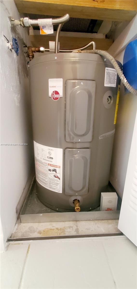 utility room featuring electric water heater