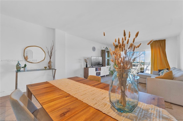 dining space featuring light tile patterned flooring