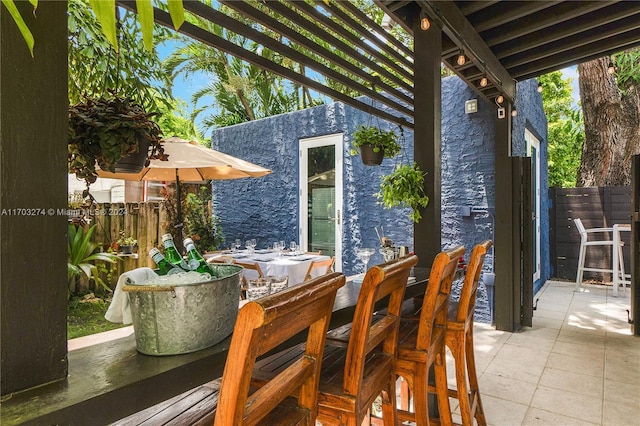 view of patio featuring a pergola and exterior bar