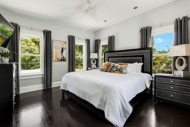 bedroom with ceiling fan and dark hardwood / wood-style flooring