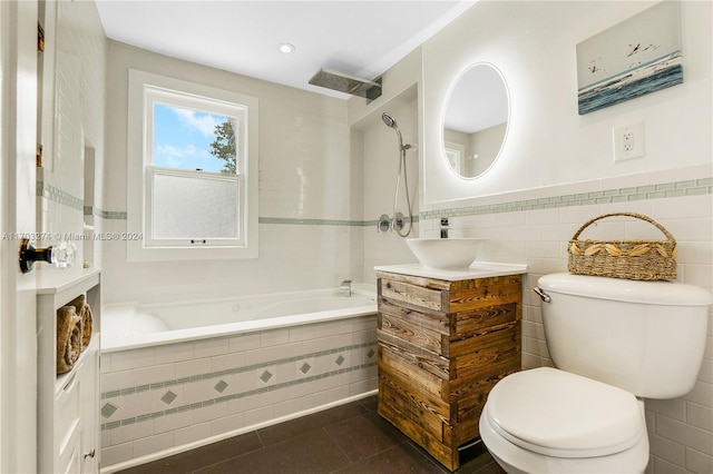 bathroom featuring tile patterned flooring, vanity, toilet, and tile walls