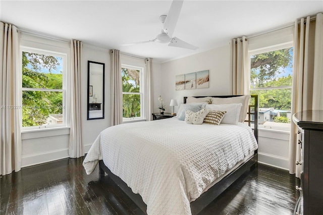 bedroom with dark hardwood / wood-style floors, multiple windows, and ceiling fan